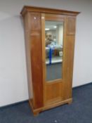 An Edwardian oak mirror door wardrobe