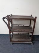 A teak outdoor three tier serving trolley