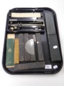 A tray containing cut throat razors, Rabone folding wooden ruler, a slide rule in case,