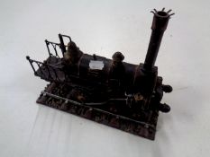 A metal model of a 19th century steam engine on track
