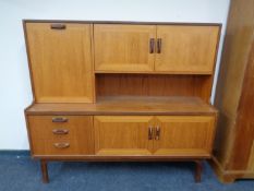 A mid 20th century teak G Plan cocktail sideboard on raised legs