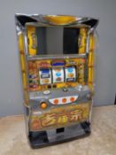 A Japanese table top electric fruit machine with key