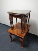 A nest of three tables with tooled leather inset panels together with a further contemporary lamp