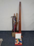 A box containing walking sticks, parasol, draftsman's rules,