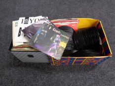 A case and a box containing a large quantity of vinyl 7 inch singles to include The Jam,