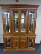 An American style four door display cabinet fitted cupboards beneath