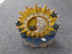 A cast iron sun and moon doorstop