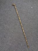 A vintage banded horn walking stick with brass dog's head handle