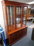 A Morris Furniture triple door bookcase fitted cupboards and drawers beneath