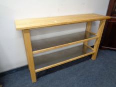 A contemporary pine kitchen island with stainless steel shelves below