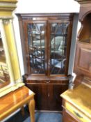 A mahogany double door corner display cabinet fitted cupboard and drawer beneath