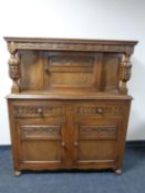 A 20th century carved oak buffet back sideboard