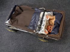 A 1970s folding doll's pram together with two plastic dolls