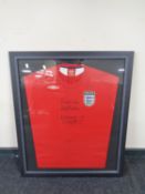 An England football shirt signed 'Best Wishes, Bobby Robson and Malcolm McDonald',