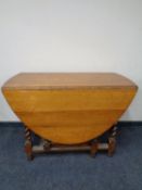 An Edwardian oak barley twist gate leg table