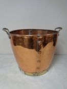 A brass and copper twin handled coal bucket