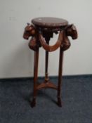 A reproduction horse head plant stand