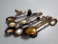 A box containing silver figure of a cat, silver thimble,