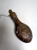 A 19th century copper and brass embossed shot flask by G & JW Hawksley (spring a/f)