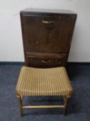 A 20th century John Carter double door record cabinet together with a gold Lloyd Loom dressing