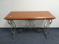 A contemporary side table on cast iron and brass base with a brown tooled leather inset panel