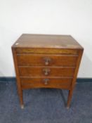 An Edwardian oak three drawer music chest