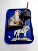 A tray containing two cast iron door stops,