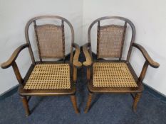 A pair of early 20th century stained beech and bergere armchairs with simulated bamboo frames