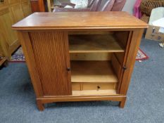A mid century shutter door cabinet