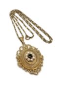 A 9ct gold pendant locket suspended upon a 9ct gold chain, set with pearls and a garnet,