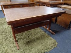 A mid century pull out dining room table together with six carved oak dining chairs