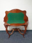 A Victorian mahogany turnover topped card table with shaped under stretches