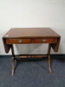 A reproduction mahogany sofa table