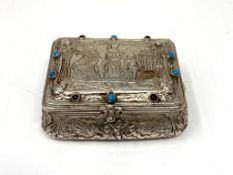 A continental white metal snuff box with cabochon decorated lid