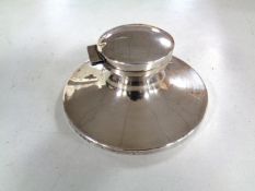 A silver capstan inkwell