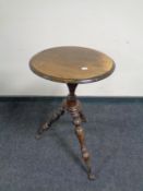 A small antique tripod table with glass ball feet