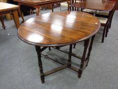 An Edwardian oak gate leg table and a small footstool