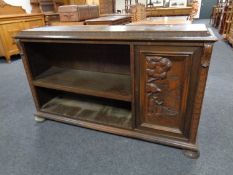 A continental carved oak low bookcase
