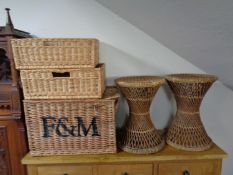 Three wicker baskets together with a pair of plant stands