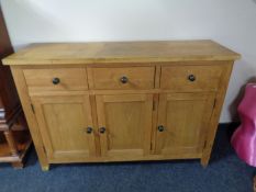 A light oak three drawer sideboard