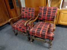 Two oak framed armchairs in red and black upholstery