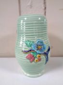A Clarice Cliff Newport Pottery vase on ribbed ground with floral blossom