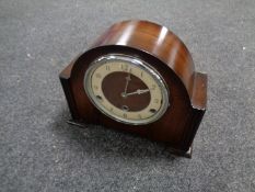 An early 20th century mahogany cased mantel clock with key and pendulum