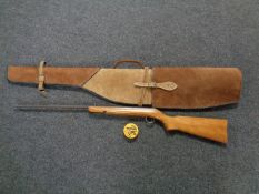 An air rifle in brown suede stitched carry case with part tin of pellets, .
