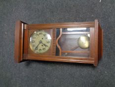 An Edwardian oak wall clock
