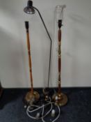 A metal reading lamp together with two further standard lamps and a light fitting