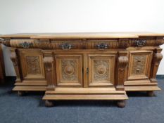 A 19th century light oak breakfronted sideboard