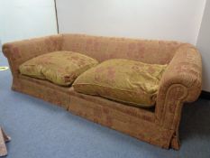 A pair of large over sized fabric settees in traditional print