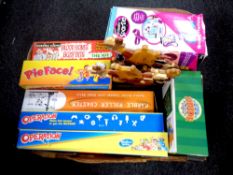 A box of contemporary board games and toys