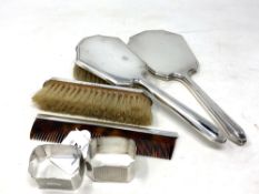 Two silver napkin rings, Birmingham 1931, together with four piece silver dressing table set.